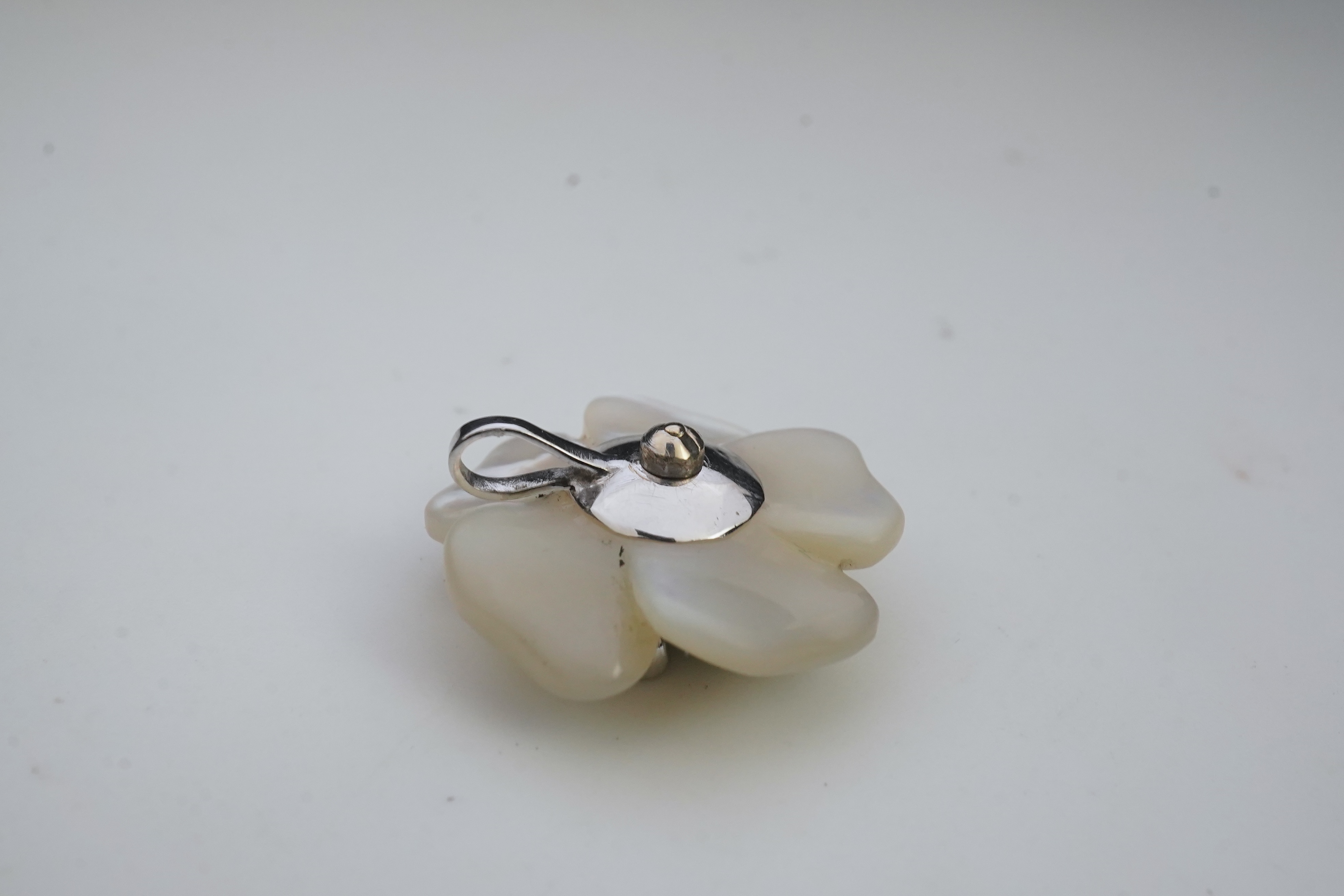 A mother of pearl and diamond pendant